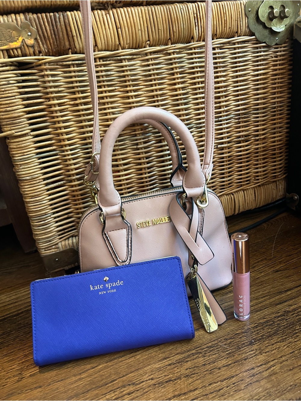 Purple Kate Spade wallet with pink Steve Madden crossbody and Lorac lipgloss